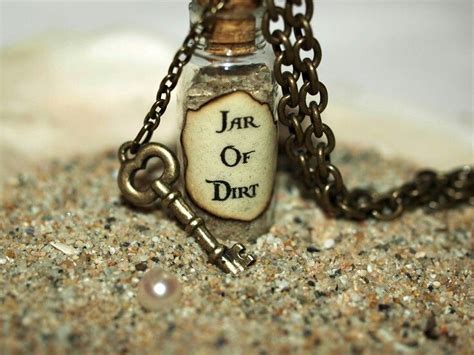 Jar of Dirt and Key in the Sand