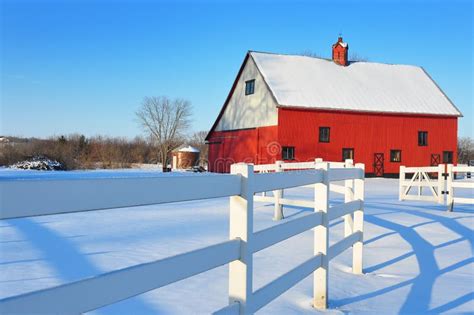 Red Barn with a White Fence with a Snow Landscape Stock Image - Image ...