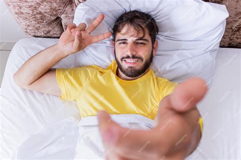 Premium Photo Man Lying In Bed Taking A Selfie