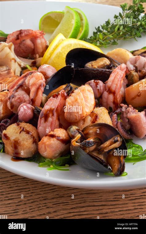 shrimp and Octopus on a white plate Stock Photo - Alamy