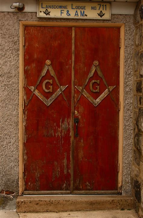 An Old Red Door With Two Masonic Symbols On It