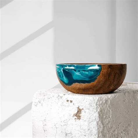 A Wooden Bowl Sitting On Top Of A White Block