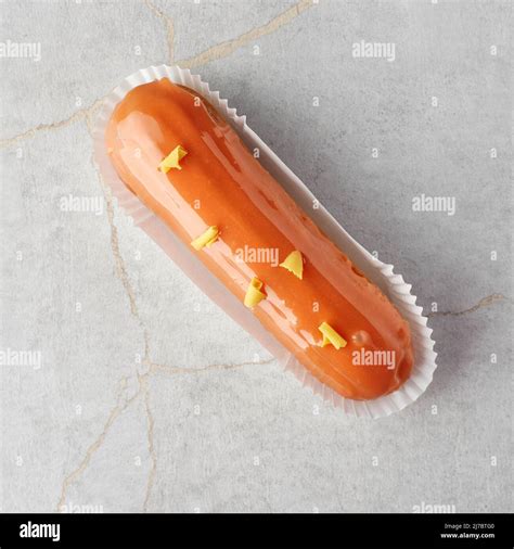 Traditional French Dessert Eclair With Custard And Glaze On A Stone Background Confectionery