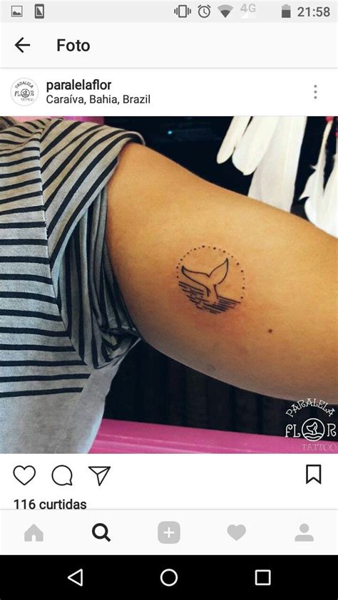 A Person With A Small Tattoo On Their Arm