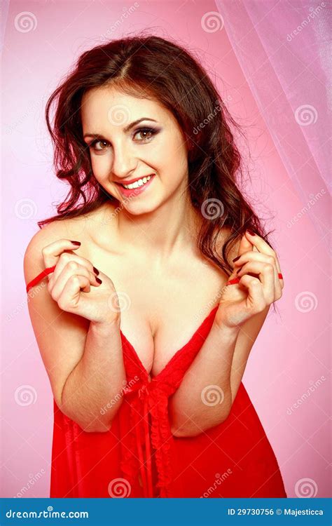 Seductive Brunette Woman In Red Lingerie On A Pink Background Stock