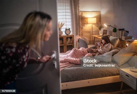 Mom Spying On Her Daughter While She Is Using The Phone In Bedroom