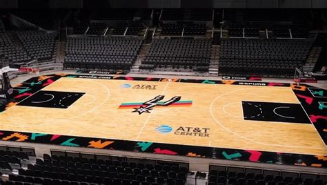 An Indoor Basketball Court Is Decorated With The Atlanta Hawks Logo And