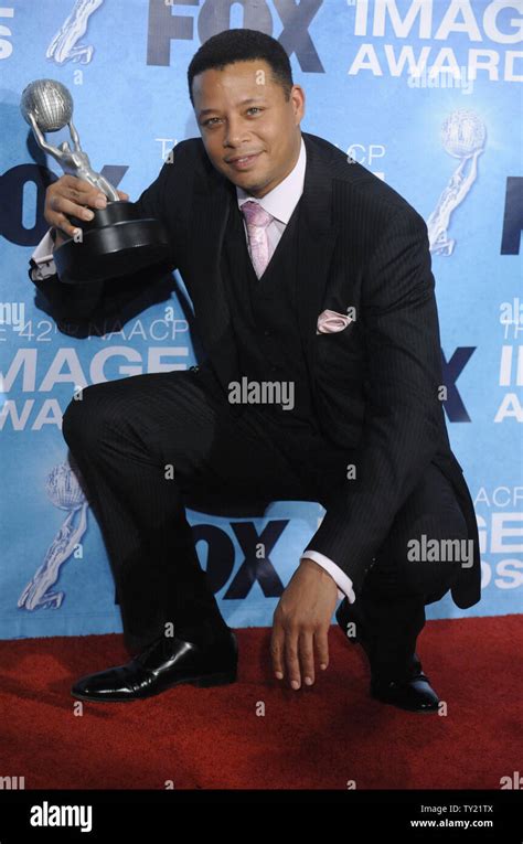 Terrence Howard poses backstage with his award at the 42nd NAACP Image ...