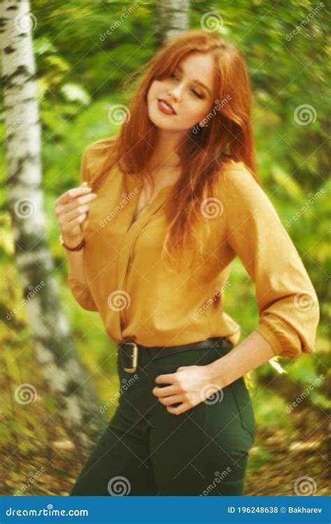 Outdoor Portrait Of A Beautiful Redhead Woman In Autumn Forest Stock