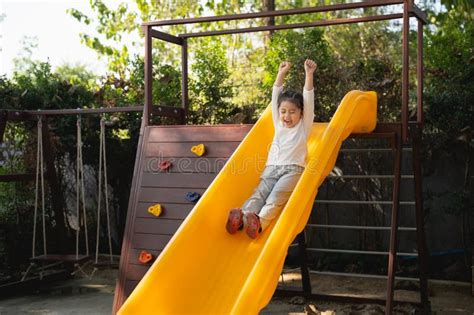 Cute Asian Girl Smile Play On School Or Kindergarten Yard Or Playground