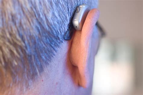 Premium Photo Close Up Of Senior Man Wearing Hearing Aid Indoors