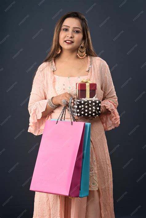 Premium Photo Beautiful Woman Wearing Indian Traditional Dress Holding Shopping Bags And T