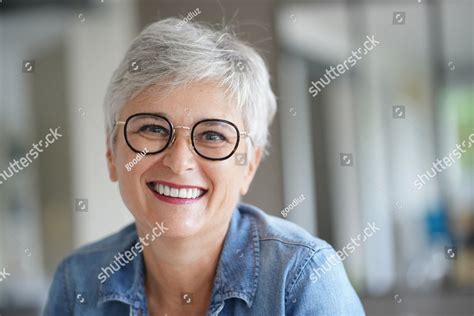 Portrait Of A Beautiful Smiling 50 Year Old Woman With White Hair A