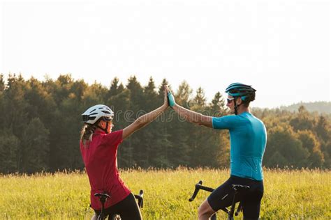 Two Road Cyclists On A Glade With Mountain View At Sunset Aerial Shot