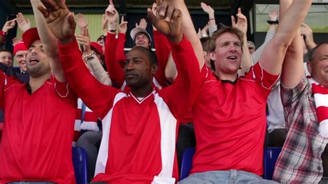 Enthusiastic Crowd Of Spectators Watching A Sports Game Or Football