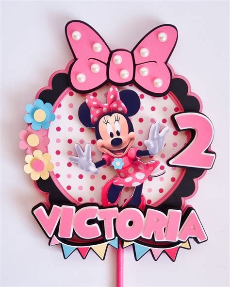 A Minnie Mouse Birthday Cake Topper With The Name Victoria On It