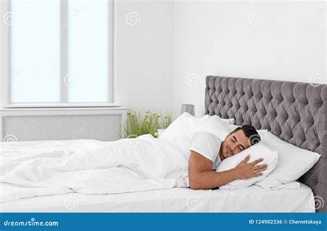 Young Man Sleeping In Bed With Soft Pillows Stock Photo Image Of