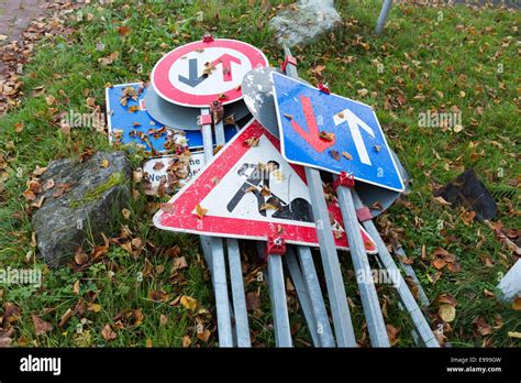 A pile of metal road signs lying on the ground Stock Photo - Alamy