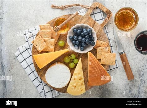 Assortment Of Cheese Honey Cracker Blueberries Grapes With Red And