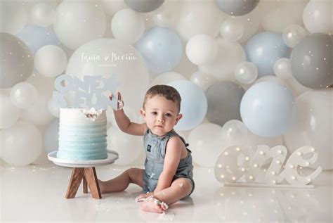 A Baby Boy Sitting In Front Of A Cake