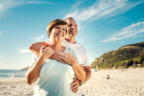 We Chose The Perfect Day To Be At The Beach A Mature Couple Spending The Day At The Beach