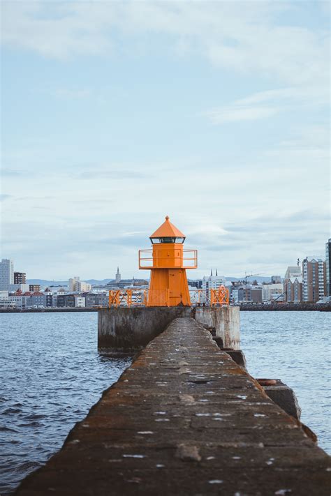 A Lighthouse on the Body of Water · Free Stock Photo