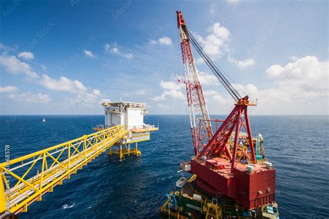 Large crane vessel installing the platform in offshore Stock Photo ...