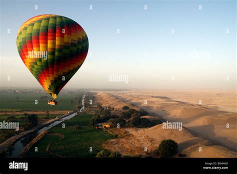 Hot Air Balloons Flying Over The Desert Villages And Fields Near Habu