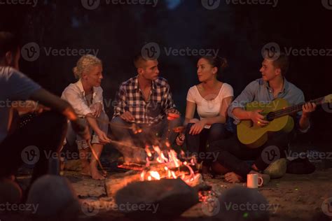 Young Friends Relaxing Around Campfire 10683611 Stock Photo At Vecteezy