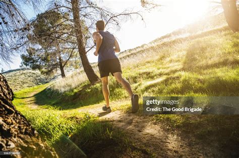 Rear View Of Man Jogging In Park High Res Stock Photo Getty Images