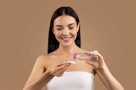 Smiling Beautiful Naked Woman Using Micellar Water And Cotton Pad Stock