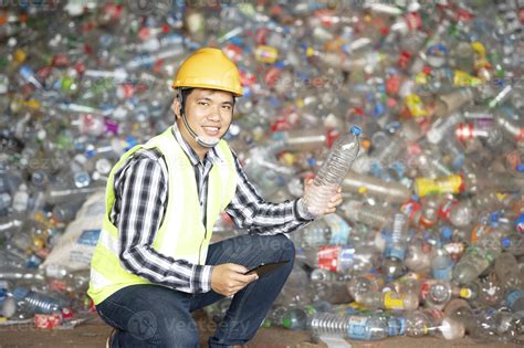A worker controls the recycling of a recycling plant. Plastic bottles