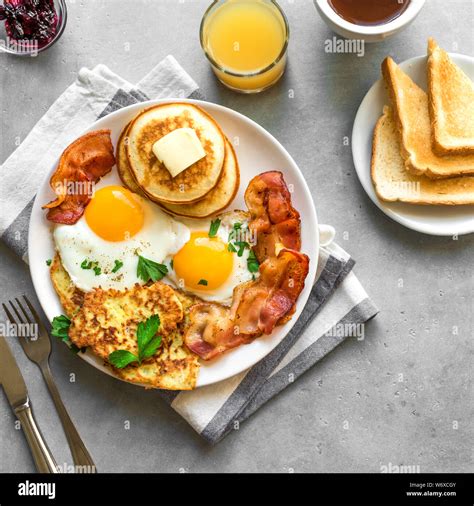 Full American Breakfast on gray table, close up. Sunny side fried eggs ...