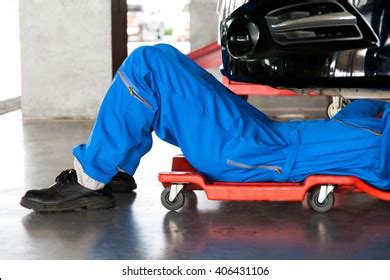 Mechanic Blue Uniform Lying Down Working Stock Photo 406431103