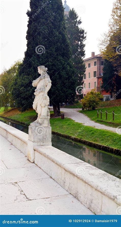 Statue River Tree And Street In Castelfranco Veneto In Italy Stock