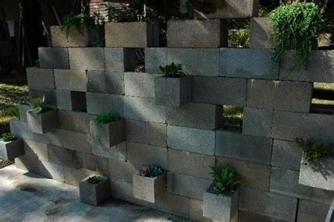 A Wall Made Out Of Cinder Blocks With Succulents Growing On It S Sides