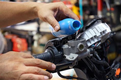 Mechanic Check And Add Brake Fluid On Motorcycle Brake Reservoir In