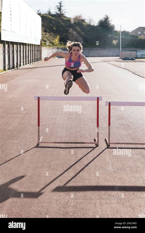 Athlete Jumping Over Hurdle Hi Res Stock Photography And Images Alamy