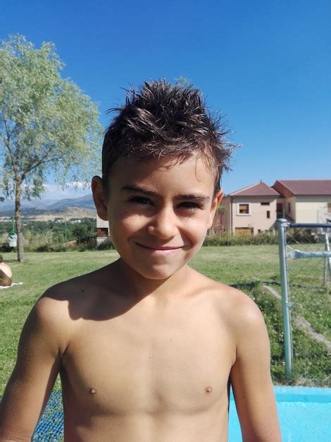 Premium Photo Close Up Portrait Of Happy Shirtless Boy Standing In Yard