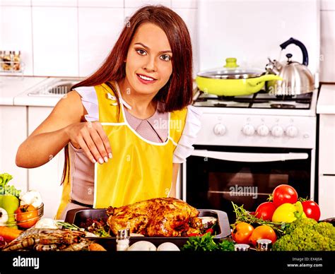 Woman Cooking Chicken At Kitchen Stock Photo Alamy