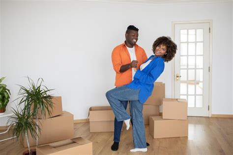 Premium Photo Happy Black Couple Dancing Together Among Unpacked