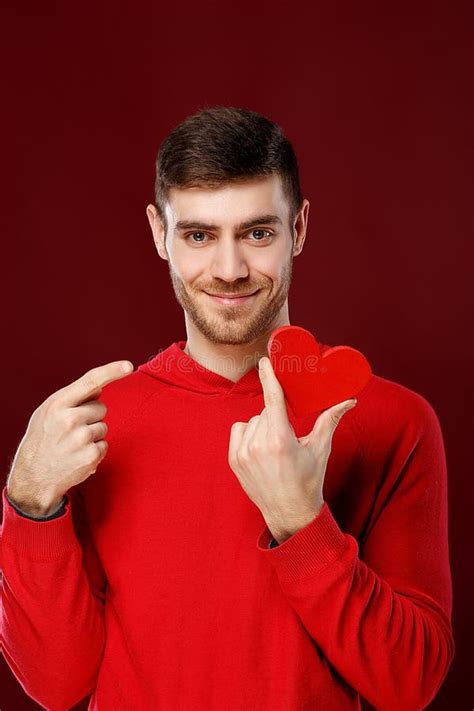 Young Handsome Man With A Red Heart In His Hands On Valentine Day Stock