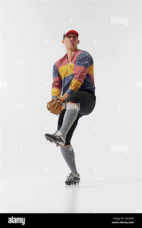 Funny meme emotions. Full-length image of young guy, baseball player in position, serving ball ...