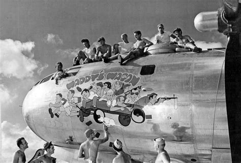 B-29 Superfortress crew and their mascot "Damit" watch ground crewman ...