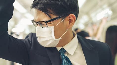 Premium Photo Young Man Wearing Face Mask Travels On Crowded Subway Train