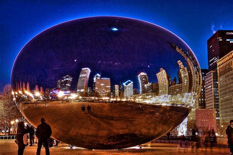 A Couple Looks On Chicago S Cloud Gate More Commonly Known As The