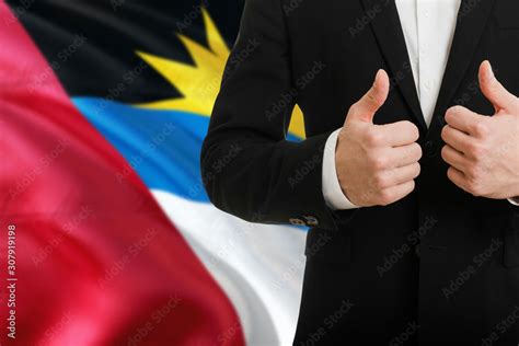 Antigua And Barbuda Businessman Showing Thumbs Up Behind Country Flag