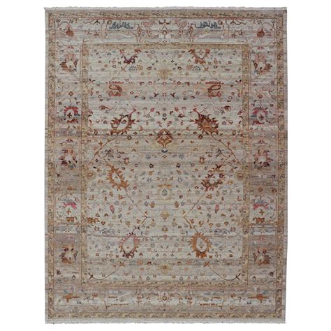 Modern Oushak Muted Rug In Earthy Tones On A Cream Background For Sale