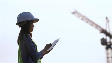 Female Civil Engineering Working With Tablet On Construction Site