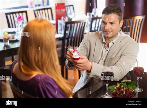 Handsome Man Proposing Marriage To His Pretty Girlfriend In A Classy